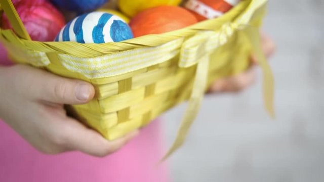 A child with Easter eggs. Child's hands with a basket of Easter eggs.