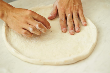 Stretching pizza dough 
