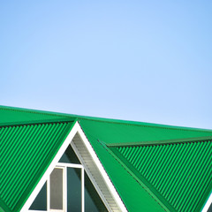 Fototapeta premium The house with plastic windows and a green roof of corrugated sheet