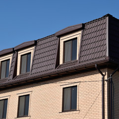 The house with plastic windows and a roof of corrugated sheet