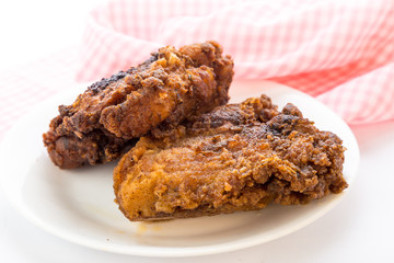 Fried Chicken Thighs on Plate with Bright Light from Behind
