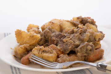 Venison Stew Serving Piled High on Platter against White BG with Copy Space