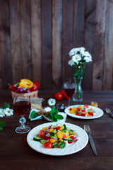 Spring vegetable salad. Healthy diet. First person view. Proper nutrition. Still life of daisies, a glass of wine fresh pepper, herbs and cutlery. Free space for lettering.