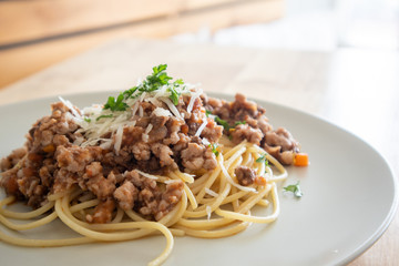 Homemade spaghetti served on wooden table.