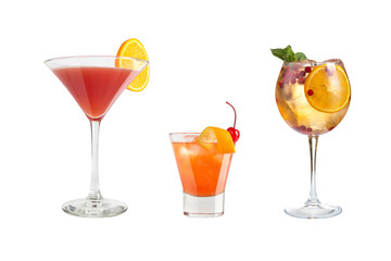A variety of alcoholic drinks, beverages and cocktails on a white background. Three refreshing drinks in different glass goblets.