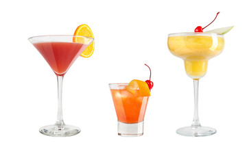 A variety of alcoholic drinks, beverages and cocktails on a white background. Three popular drinks in glass goblets.