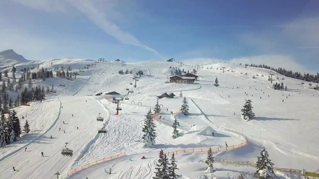 4K Drone flying over a busy snowy slope in the French Alps, Flachau, Austria