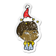 distressed sticker cartoon of a amazed boy wearing santa hat