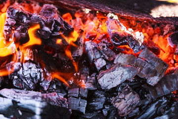 Burning charcoal in the open grill.