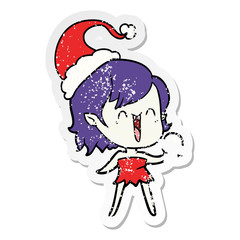 cute distressed sticker cartoon of a happy vampire girl wearing santa hat