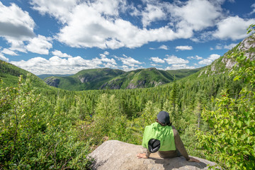 Hiker and beautiful view in Les Grands-Jardins National Park, Quebec