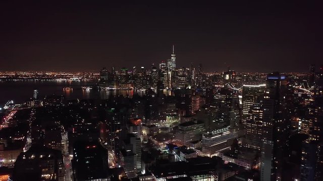 The New York City Skyline at night, taken from a drone.  This view of the beautiful manhattan skyline is taken from Brooklyn and shows the freedom tower and Lower Manhattan.