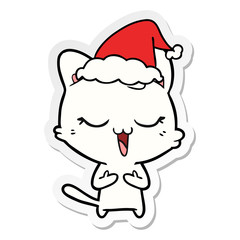 happy sticker cartoon of a cat wearing santa hat