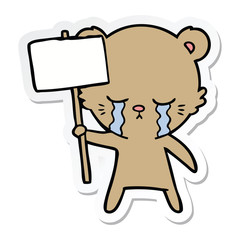 sticker of a crying cartoon bear with sign post