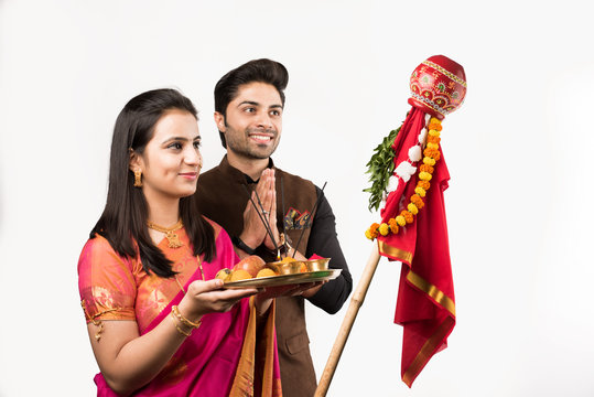 Gudi Padwa Celebration - Indian smart couple performing puja on Hindu New year , isolated over white background