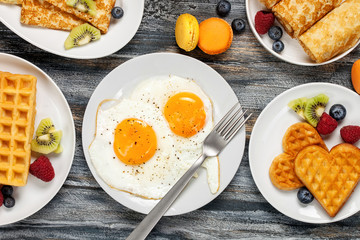 Breakfast - fried eggs, pancakes, crepes, croissants