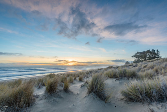 Sunset at Limantour Beach, Pt. Reyes California. Facing northwest with saturated colors and reflections in the water.