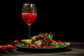 grilled ribs with a in sour sweet berry sauce served with green seedlings served over big plate with a glass of red wine. concept of Asian cuisine. restaurant serving. place for text