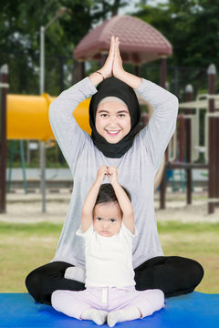 Muslim Woman And Her Daughter Exercise Yoga