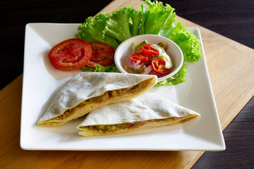Roti mataba and in white dish on wooden table Muslim food, Halal food and vegetable pickled sauce in cup on wooden chopping board