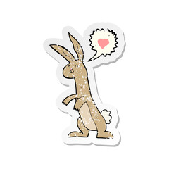 retro distressed sticker of a cartoon rabbit in love
