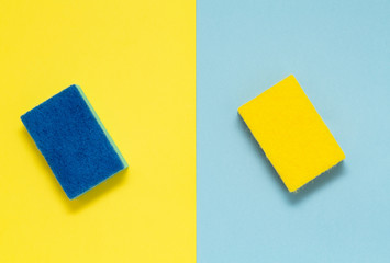 Double sided sponges for dishes on a multicolored background, minimalism.