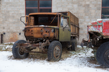 Fototapeta premium Old damage cars in industrial park. Rubber an iron. Travel urban street photo 2019.
