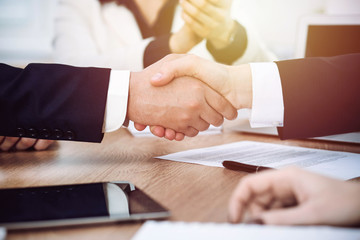 Obraz na płótnie Canvas Business people shaking hands at meeting or negotiation in the office. Handshake concept. Partners are satisfied because signing contract