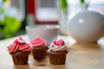 pink and white muffins with heart and teapot