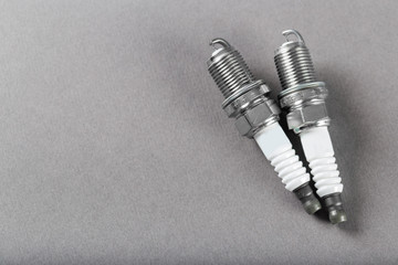 Fototapeta premium Two spark plugs on black background