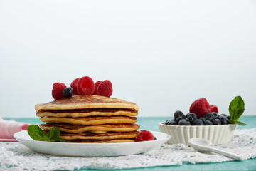 pancakes with fruit and maple syrup