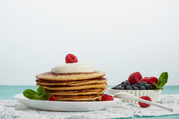 pancakes with fruit and maple syrup