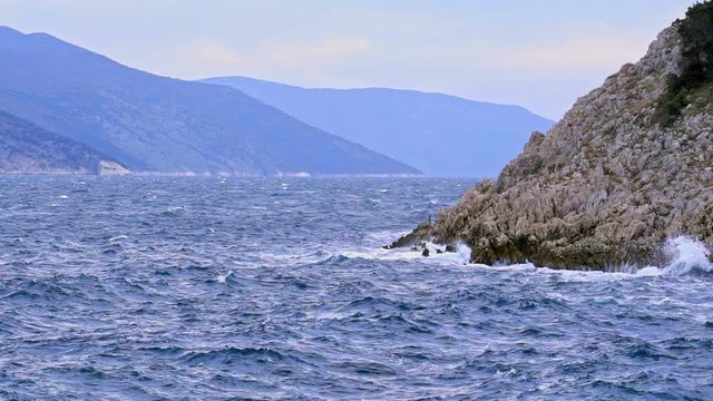 Beautiful detail of the movement of the sea waters of the Adriatic Sea on a cloudy day. Brestova Croatia. Flat plane. Slow motion