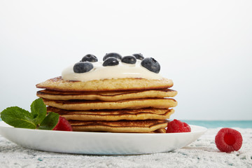 pancakes with fruit and maple syrup