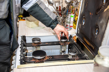 MINSK, BELARUS - 18 FEBRUARY, 2019: gas worker checks the gas stove