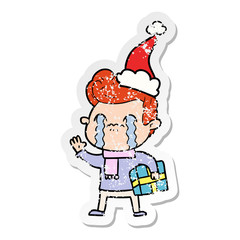 distressed sticker cartoon of a man crying wearing santa hat
