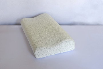 Modern pillow on a foam base on a light background.