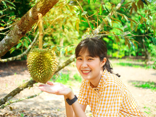 Durian lover woman holding durian in the field