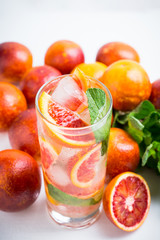 Mojito with red oranges. Selective focus. Shallow depth of field.