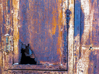 Rusty old iron box with a leaky door. 