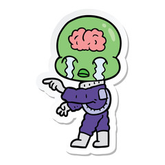 sticker of a cartoon big brain alien crying and pointing
