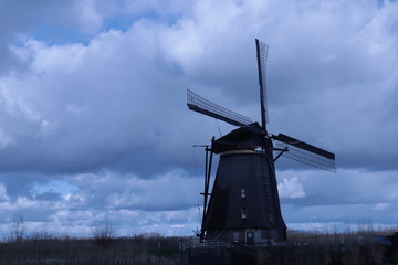 windmill of kinderdijk , beautiful netherlands landscape with sky and clouds background, historical travel photo