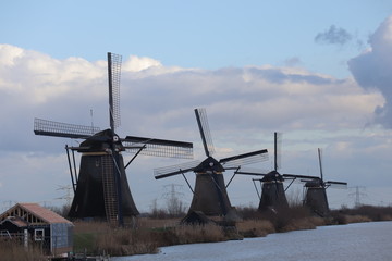 windmill of kinderdijk , beautiful netherlands landscape with sky and clouds background, historical travel photo