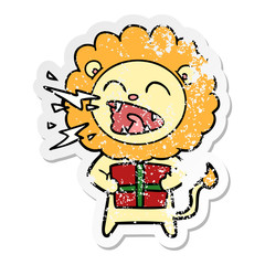 distressed sticker of a cartoon roaring lion with gift