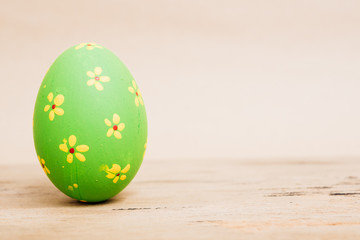 Beautiful Easter Green egg on wooden background,