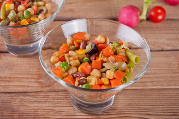 Homemade Mexican salad in a bowls with beans, corn, tomato, pepper and other vegetables.