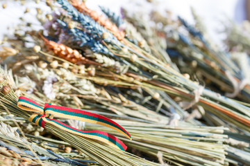 Traditional bouquets of ripe cereal wheat, linen, field grass and seeds. Lithuanian flag colors...
