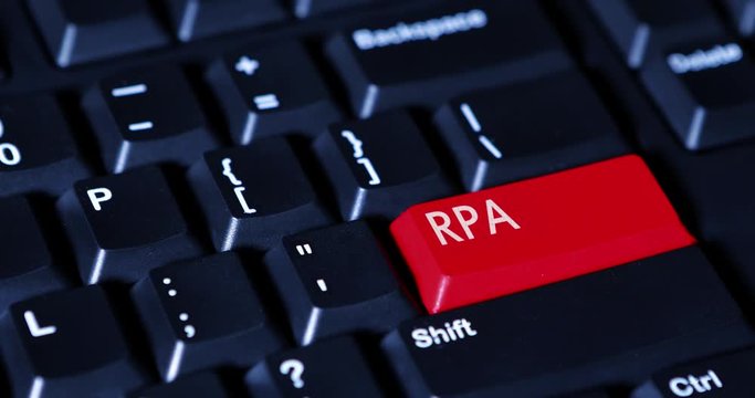 Closeup of human finger pressing RPA (Robotic Process Automation) button on the computer keyboard