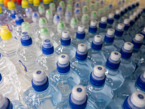 Lid plastic water bottle in the market. multi-colored plastic bottle caps	