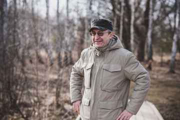 Mature European man with a good mood, outdoor portrait. The concept of life after 50 years 